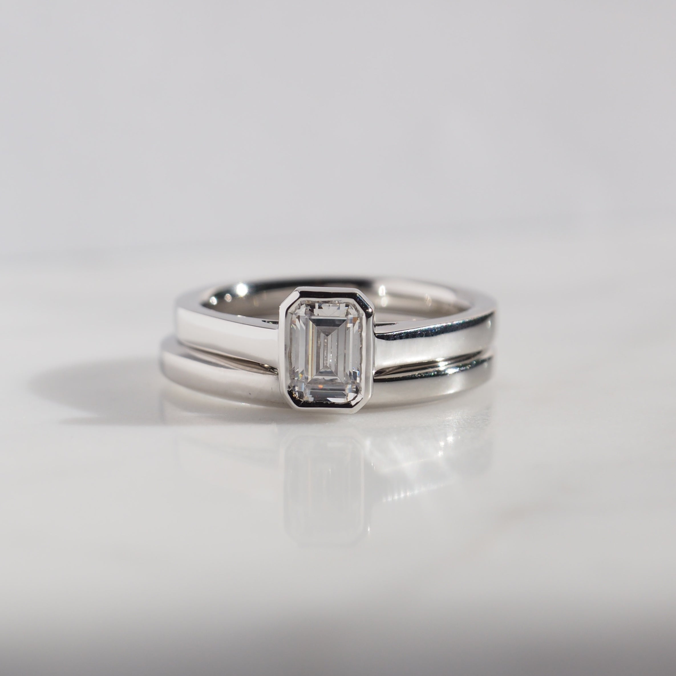 EMERALD CUT DIAMOND VERTICAL BEZEL SET ENGAGEMENT RING 0.50 CT.